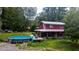 Red house exterior with covered porch and above ground pool at 268 Arnold Mill Rd, Woodstock, GA 30188