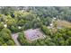 Aerial view of property with a large parking area and surrounding woods at 268 Arnold Mill Rd, Woodstock, GA 30188