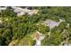 Aerial view showing a property with trees, a pond, and nearby businesses at 268 Arnold Mill Rd, Woodstock, GA 30188