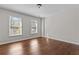 Bright bedroom featuring wood flooring and two large windows at 906 Fox Croft Pl, Canton, GA 30114
