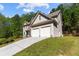 House exterior with three-car garage at 906 Fox Croft Pl, Canton, GA 30114