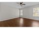 Bedroom with ceiling fan, wood floors, and two windows at 906 Fox Croft Pl, Canton, GA 30114