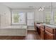 Bathroom with soaking tub, double vanity, and wood flooring at 906 Fox Croft Pl, Canton, GA 30114