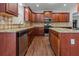 Kitchen with granite countertops, stainless steel appliances, and dark wood cabinets at 906 Fox Croft Pl, Canton, GA 30114