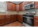 Kitchen with dark wood cabinets and granite countertops at 906 Fox Croft Pl, Canton, GA 30114