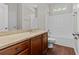 Bathroom boasts granite countertop, wood cabinets and bathtub at 906 Fox Croft Pl, Canton, GA 30114
