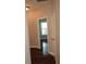 Hardwood floor hallway with a view into a room with a window and dark hardwood floors at 7025 Fletcher Dr, Winston, GA 30187