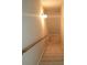 Carpeted staircase with wood railing leading to the upper level at 7025 Fletcher Dr, Winston, GA 30187