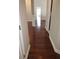 Hardwood floor hallway with access to rooms and natural light at 7025 Fletcher Dr, Winston, GA 30187
