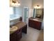 Spacious bathroom with double vanities, large mirrors, and a garden tub at 7025 Fletcher Dr, Winston, GA 30187
