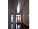 Bright and airy two story foyer with hardwood floors and elegant chandelier at 7025 Fletcher Dr, Winston, GA 30187