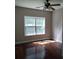 Bright bedroom featuring hardwood floors and a large window at 7025 Fletcher Dr, Winston, GA 30187