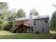 Two-story house with elevated deck, stairs and a large backyard at 7025 Fletcher Dr, Winston, GA 30187