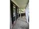 Front porch with stone flooring, white columns, and black shutters at 7025 Fletcher Dr, Winston, GA 30187