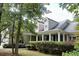 Two-story house with front porch, landscaping and partial view of neighborhood at 7025 Fletcher Dr, Winston, GA 30187