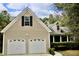 Two-story house with beige siding, two-car garage, and landscaping at 7025 Fletcher Dr, Winston, GA 30187