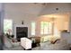 Spacious living room featuring a stone fireplace and hardwood floors, leading to a deck at 7025 Fletcher Dr, Winston, GA 30187