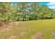 Large grassy yard with mature trees surrounding the property at 9180 Shiloh Dr, Villa Rica, GA 30180