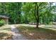 Spacious front yard with mature trees and a paved walkway at 4480 Gann Xing, Smyrna, GA 30082