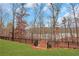 Landscaped backyard with a black metal fence and lake view at 374 Boundless Ln, Canton, GA 30114