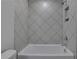 Bathroom with a shower/tub combo and diamond pattern tile at 374 Boundless Ln, Canton, GA 30114