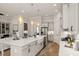 Open kitchen features a large island, white cabinetry, and stainless steel appliances at 3378 Chosen Blvd, Snellville, GA 30078