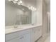 Double vanity bathroom with marble tile and large mirror at 25 Homesite Cooper E Cv, Fayetteville, GA 30215