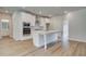 White kitchen features a large island and stainless steel appliances at 25 Homesite Cooper E Cv, Fayetteville, GA 30215
