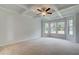 Spacious bedroom with tray ceiling, ceiling fan, and large windows at 25 Homesite Cooper E Cv, Fayetteville, GA 30215