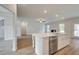 Open concept kitchen with large island and stainless steel dishwasher at 25 Homesite Cooper E Cv, Fayetteville, GA 30215