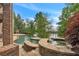 Large, freeform pool with spa and flagstone patio overlooking lake at 2867 Darlington Run, Duluth, GA 30097