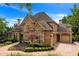 Brick house with stone accents, three-car garage, and landscaped grounds at 2867 Darlington Run, Duluth, GA 30097