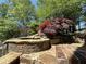 Stone water feature with cascading water and Japanese Maple tree at 2867 Darlington Run, Duluth, GA 30097