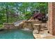 Unique pool with slide, waterfall, and flagstone patio at 2867 Darlington Run, Duluth, GA 30097
