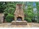 Stone fireplace on patio next to a black fence at 2867 Darlington Run, Duluth, GA 30097