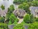 Luxury home with a circular driveway and lush landscaping at 2867 Darlington Run, Duluth, GA 30097