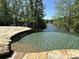 Infinity edge pool with lake view and flagstone patio at 2867 Darlington Run, Duluth, GA 30097