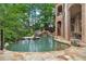 Curved pool with flagstone patio and lake view at 2867 Darlington Run, Duluth, GA 30097