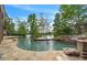 Expansive pool with lake view, flagstone patio, and firepit at 2867 Darlington Run, Duluth, GA 30097