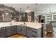 Open concept kitchen with gray cabinetry, quartz countertops, and breakfast bar at 20 10Th Nw St # 603, Atlanta, GA 30309