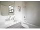 Clean bathroom with single vanity, white subway tile, and tub at 1277 Avalon Ne Pl, Atlanta, GA 30306