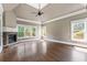 Gathering room with hardwood floors, fireplace, and multiple windows at 309 Marbella Way, Mcdonough, GA 30252