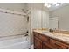 Bathroom with granite countertop, single vanity, and tub shower combo at 309 Marbella Way, Mcdonough, GA 30252