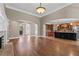 Spacious living room with hardwood floors, fireplace, and views into kitchen at 309 Marbella Way, Mcdonough, GA 30252