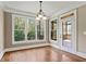 Breakfast room with hardwood floors, access to screened porch, and natural light at 309 Marbella Way, Mcdonough, GA 30252