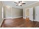 Bedroom with hardwood floors, private bathroom access and ceiling fan at 309 Marbella Way, Mcdonough, GA 30252