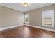 Bright bedroom with hardwood floors and two windows at 309 Marbella Way, Mcdonough, GA 30252