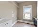 Laundry room with utility sink, storage cabinets and window at 309 Marbella Way, Mcdonough, GA 30252