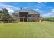Spacious backyard with screened porch and green lawn at 309 Marbella Way, Mcdonough, GA 30252