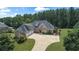 Luxury brick home with a large driveway and lush landscaping at 309 Marbella Way, Mcdonough, GA 30252